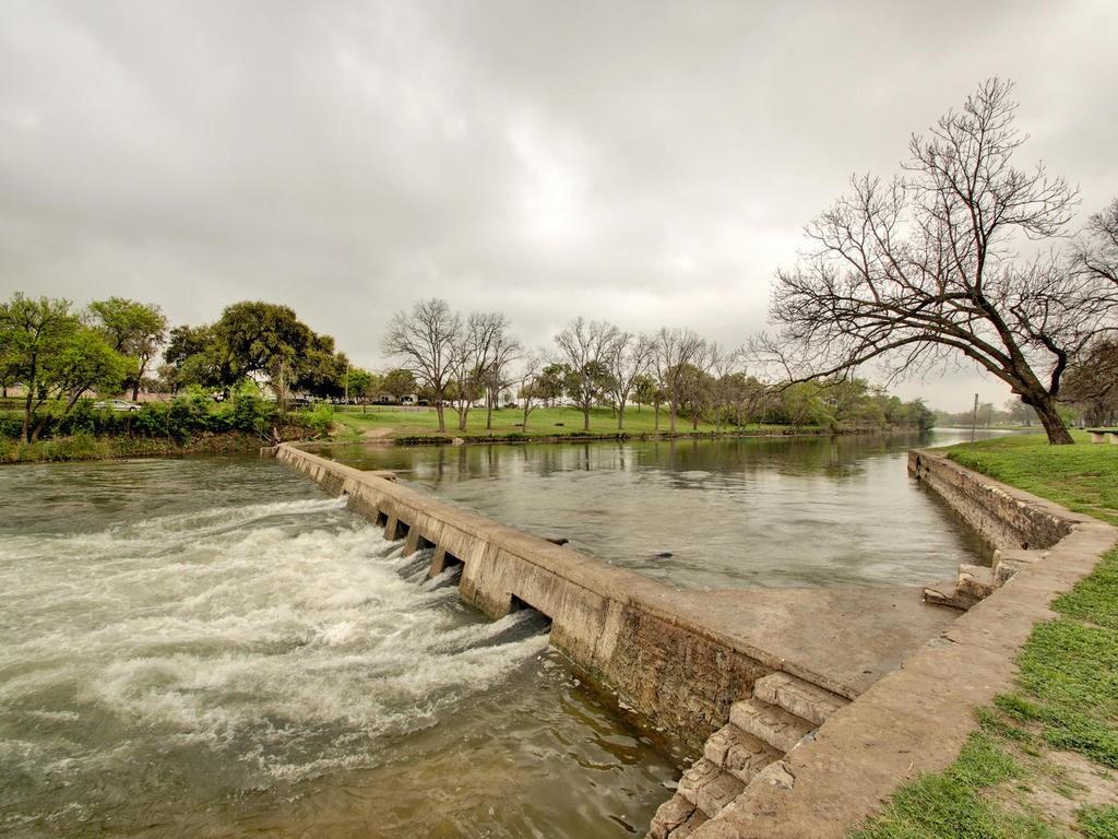513 Meadowbrook Drive Georgetown, TX 78628 - Photo 20 of 22 a view of a lake with houses in the back