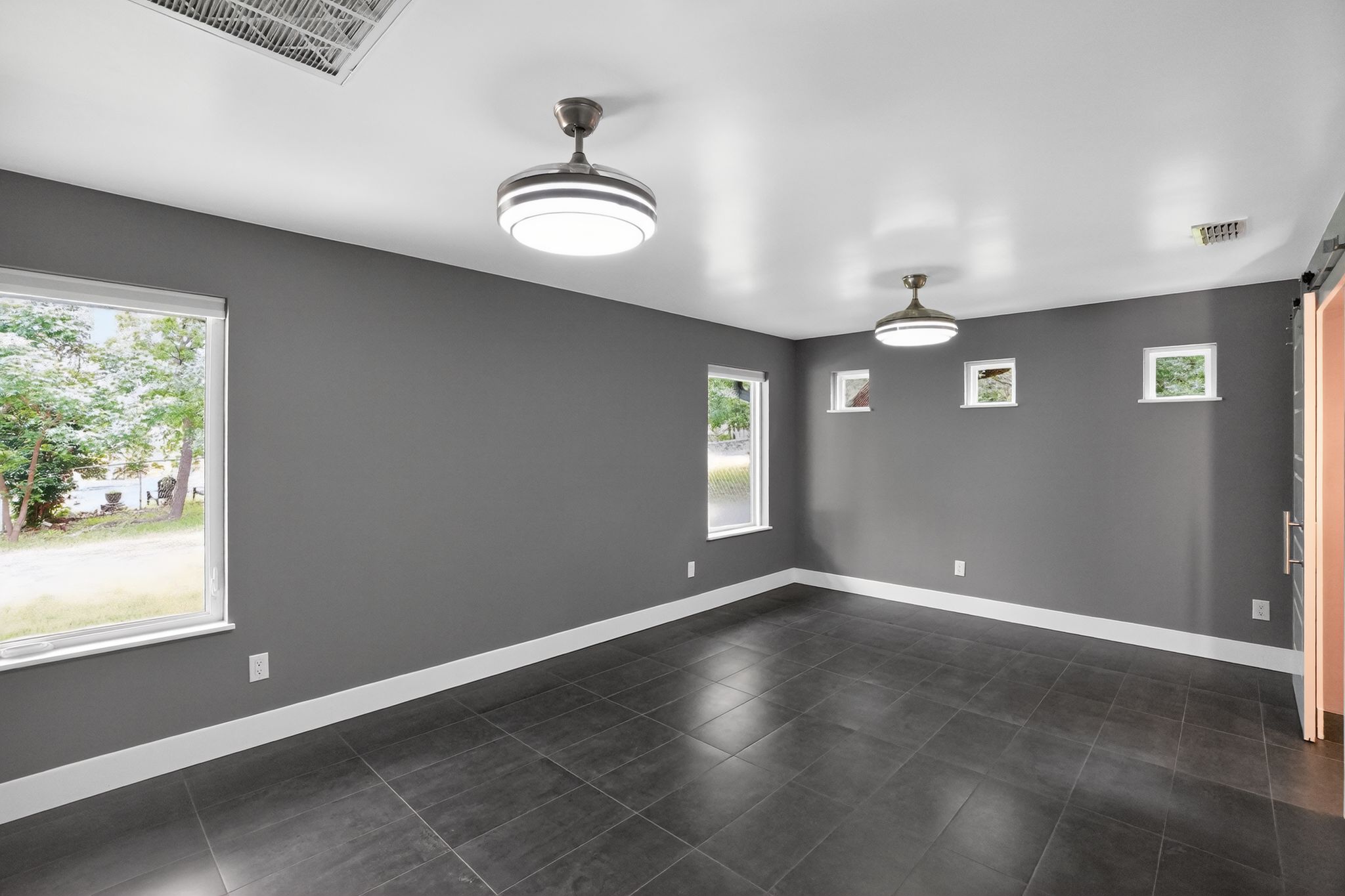 513 Meadowbrook Drive Georgetown, TX 78628 - Photo 8 of 22 an empty room with windows and chandelier fan