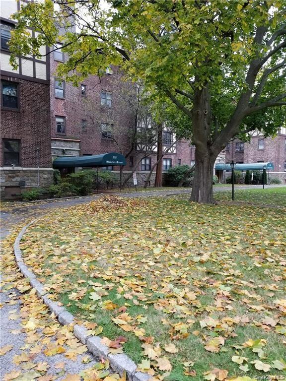 110 Stonelea Place, Unit 3B New Rochelle, NY 10801 - Photo 3 of 3 a house with trees in front of it