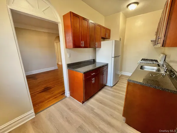 a kitchen with granite countertop a refrigerator and a stove