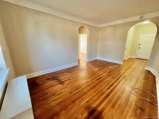 a view of a room with wooden floor