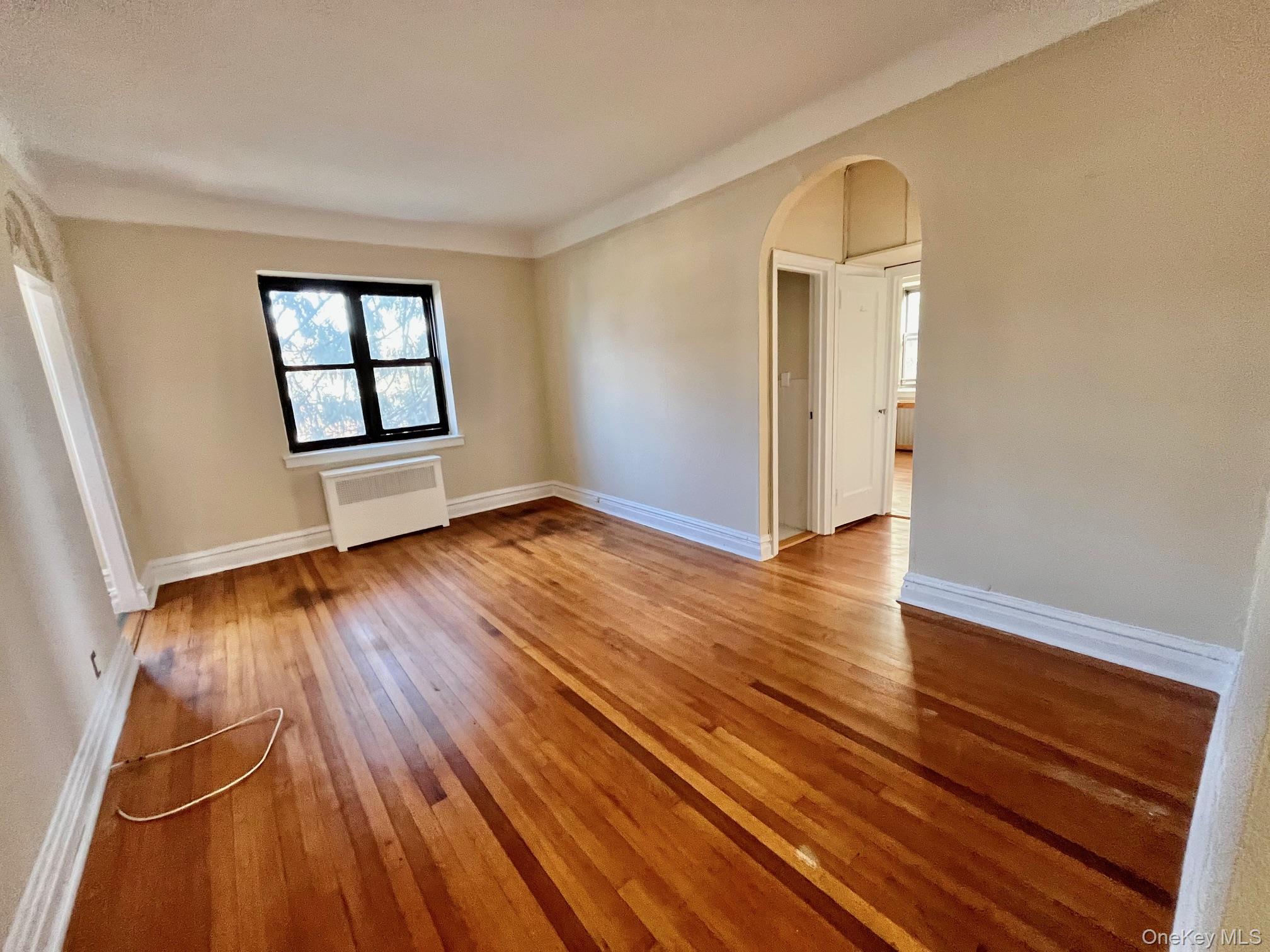 110 Stonelea Place, Unit 3B New Rochelle, NY 10801 - Photo 8 of 15 wooden floor in an empty room with a window