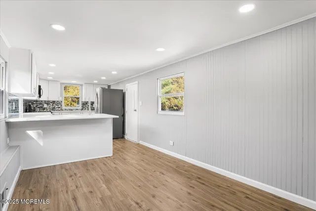 a view of kitchen refrigerator and microwave