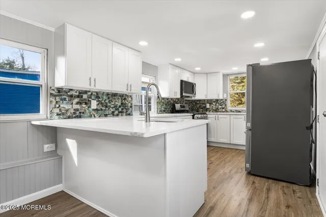 a kitchen with refrigerator and cabinets