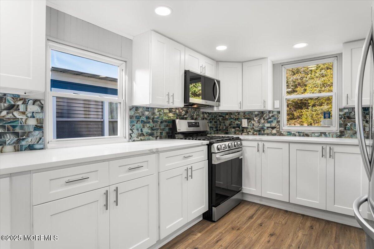 114 Cookstown New Egypt Road, Unit C7 Wrightstown, NJ 08562 - Photo 14 of 30 a kitchen with white cabinets appliances a sink and a window