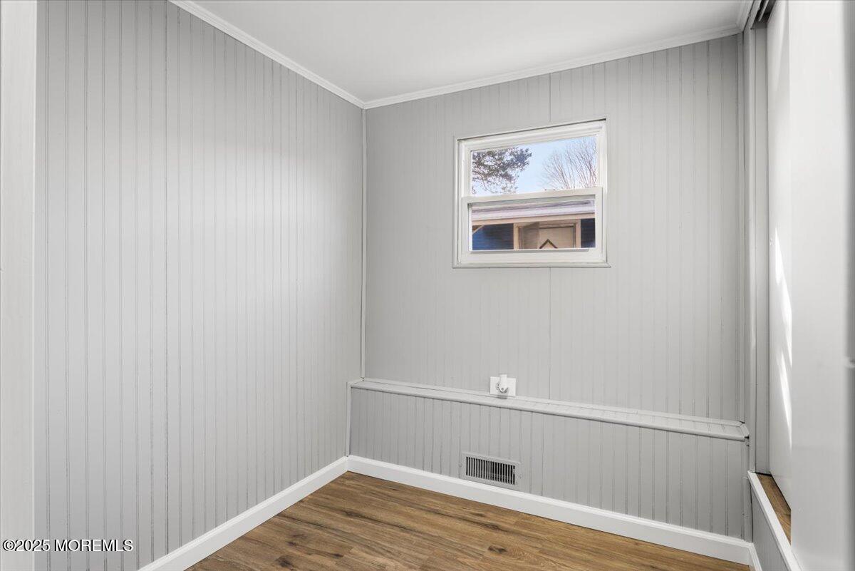 114 Cookstown New Egypt Road, Unit C7 Wrightstown, NJ 08562 - Photo 23 of 30 a view of an empty room with wooden floor and a window