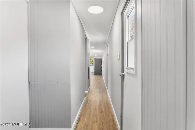a view of a hallway with wooden floor and glass doors