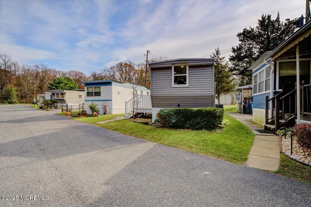 a view of a street with a white house