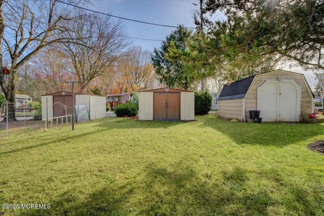 a view of a backyard with large trees
