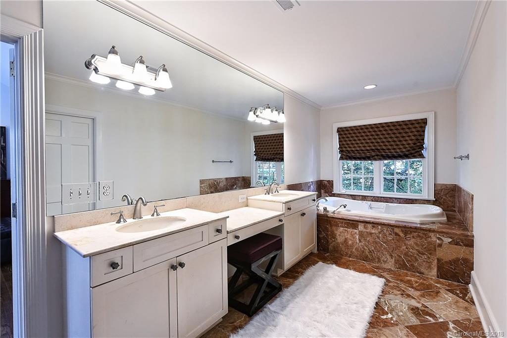 1626 Queens Road West Charlotte, NC 28207 - Photo 16 of 36 a spacious bathroom with a granite countertop sink a large mirror and a bathtub