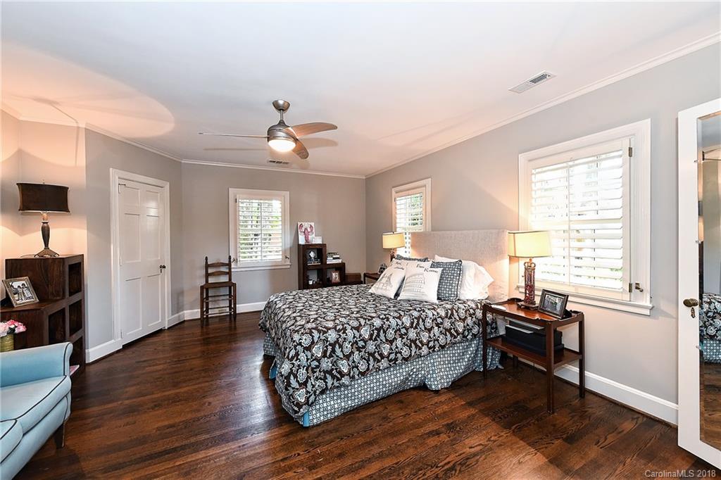 1626 Queens Road West Charlotte, NC 28207 - Photo 19 of 36 a bedroom with a bed and a chandelier