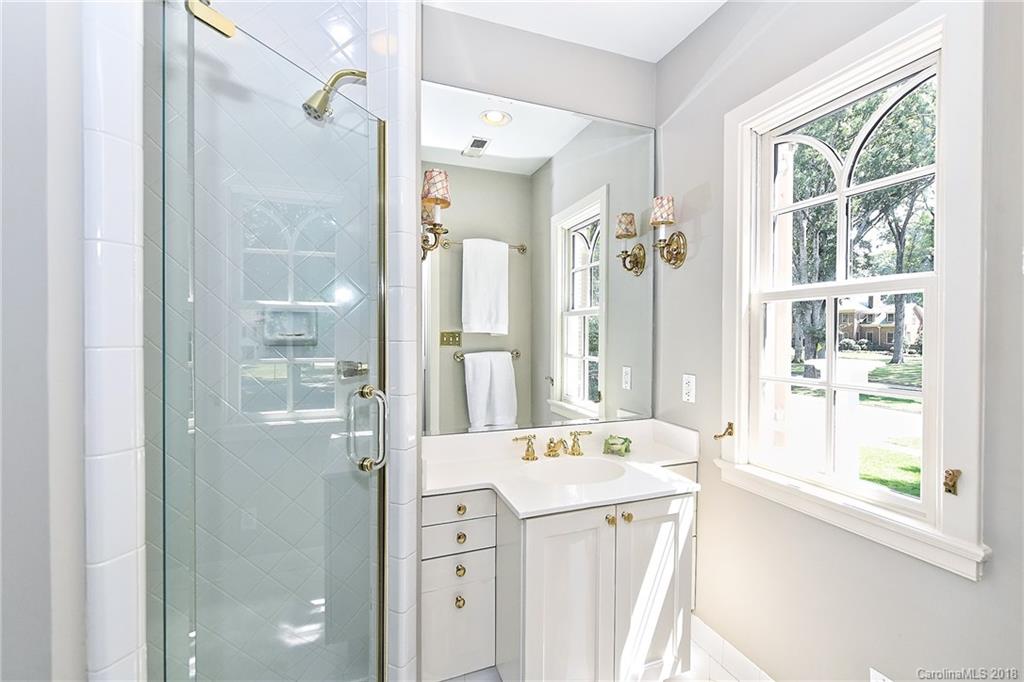 1626 Queens Road West Charlotte, NC 28207 - Photo 22 of 36 a bathroom with a shower sink and mirror