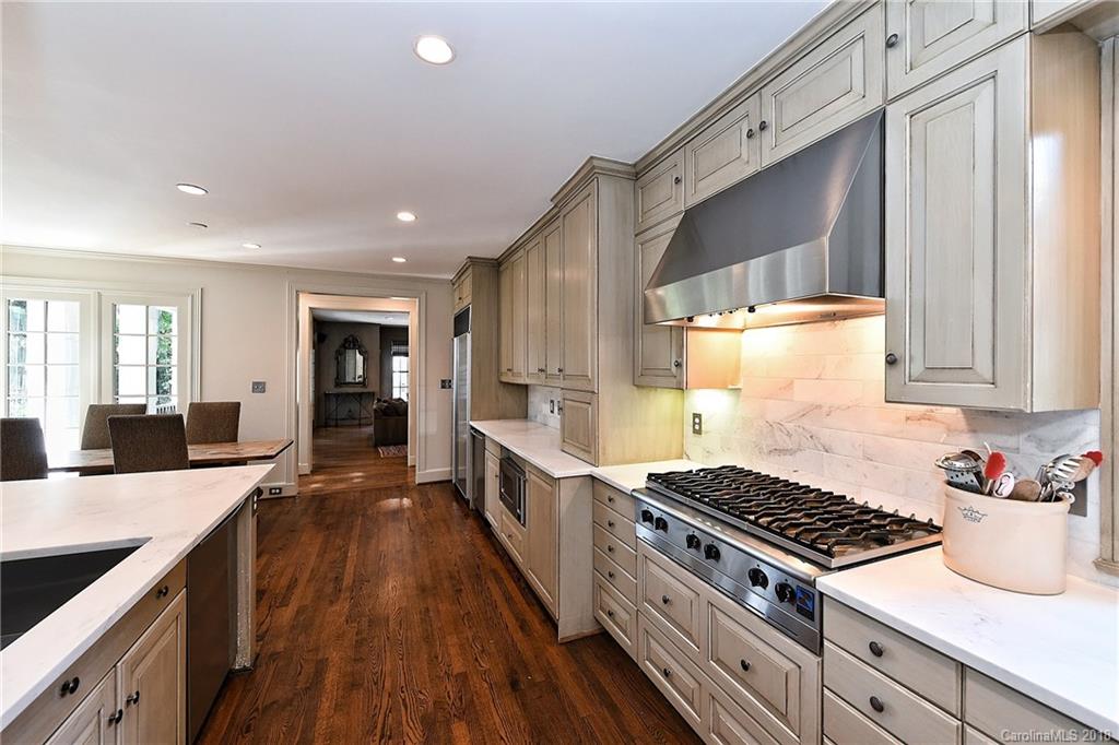 1626 Queens Road West Charlotte, NC 28207 - Photo 4 of 36 a kitchen with sink stove and cabinets
