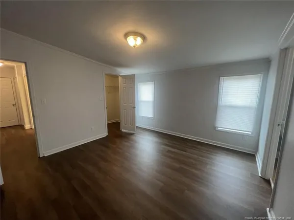 a bathroom with a double vanity sink a toilet and a tub