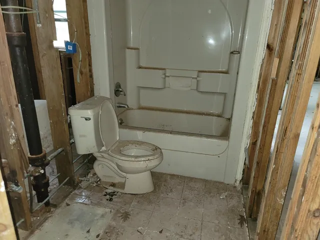 a bathroom with a toilet and a shower