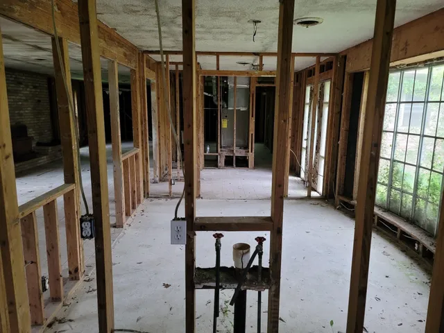 a view of living room with a floor to ceiling window and wooden floor