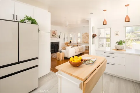 a kitchen with a sink a stove and a refrigerator