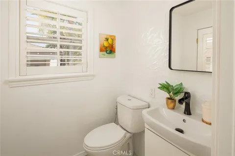 a white toilet sitting next to a bathroom sink