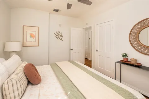 a bedroom with a bed and a painting on the wall