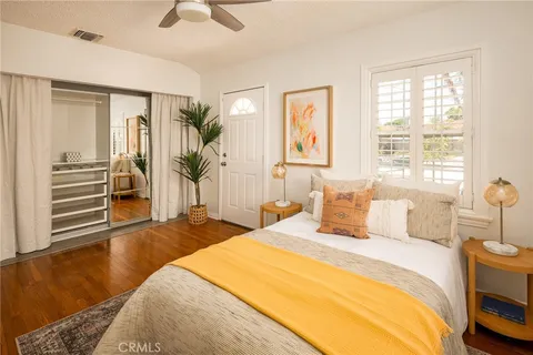 a bedroom with a bed and wooden floor