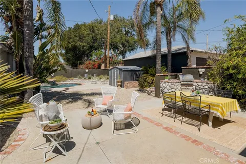 a view of backyard of house with seating space