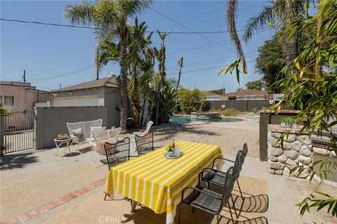 a view of backyard with swimming pool and sitting area
