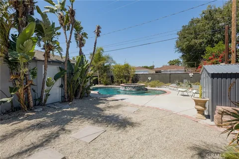 a view of yard with swimming pool and sitting area