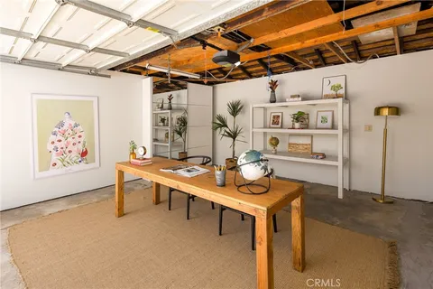 a backyard of a house with barbeque oven table and chairs
