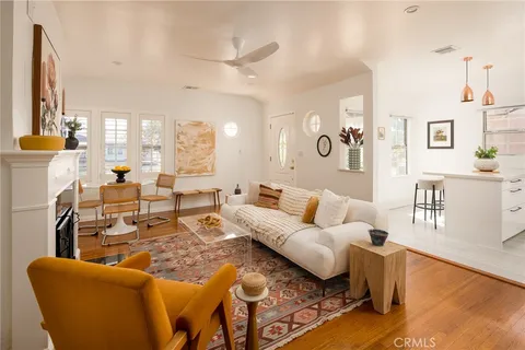 a living room with furniture fireplace and a large window