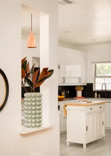 a kitchen with stainless steel appliances granite countertop a sink a stove and a wooden floors
