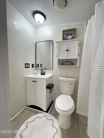 a white toilet sitting next to a bathroom sink