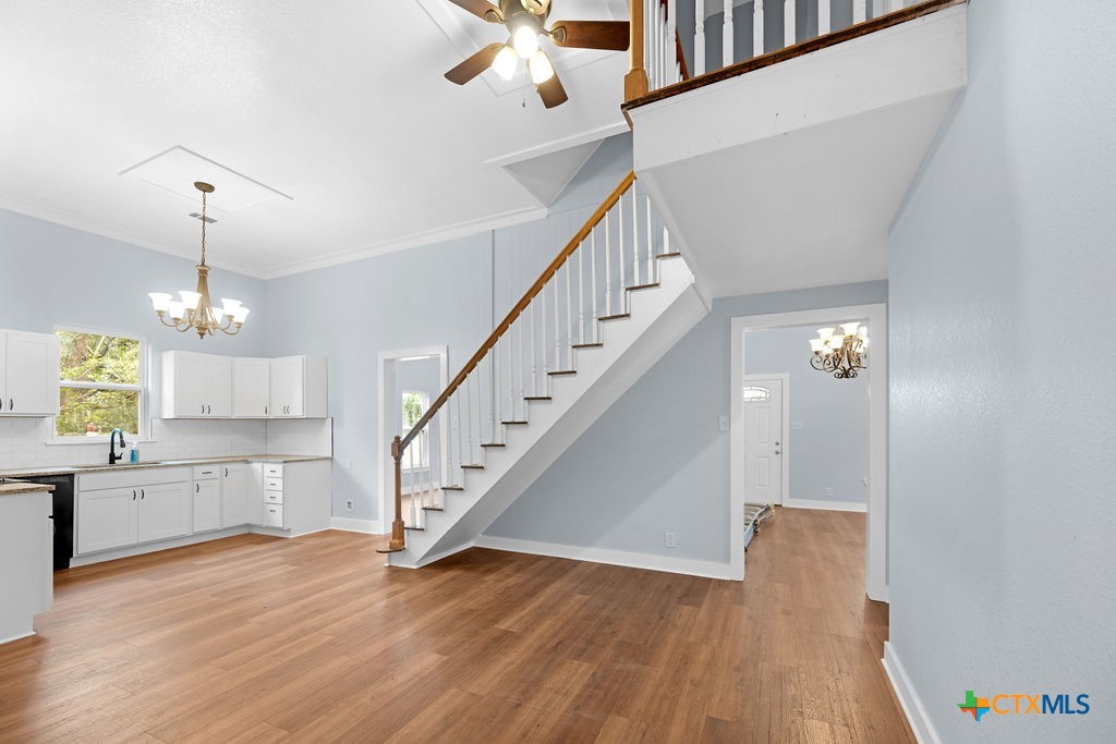 607 West 3rd Street Eddy, TX 76524 - Photo 16 of 29 a view of a kitchen with wooden floor and staircase