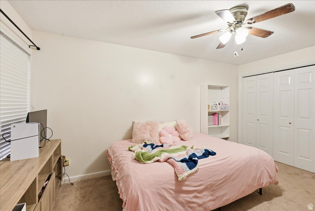 1334 Ridgewood Lane Bountiful, UT 84010 - Photo 33 of 38 Ceiling fan with light fixture, built-in shelving, bifold closet doors, and carpeted flooring