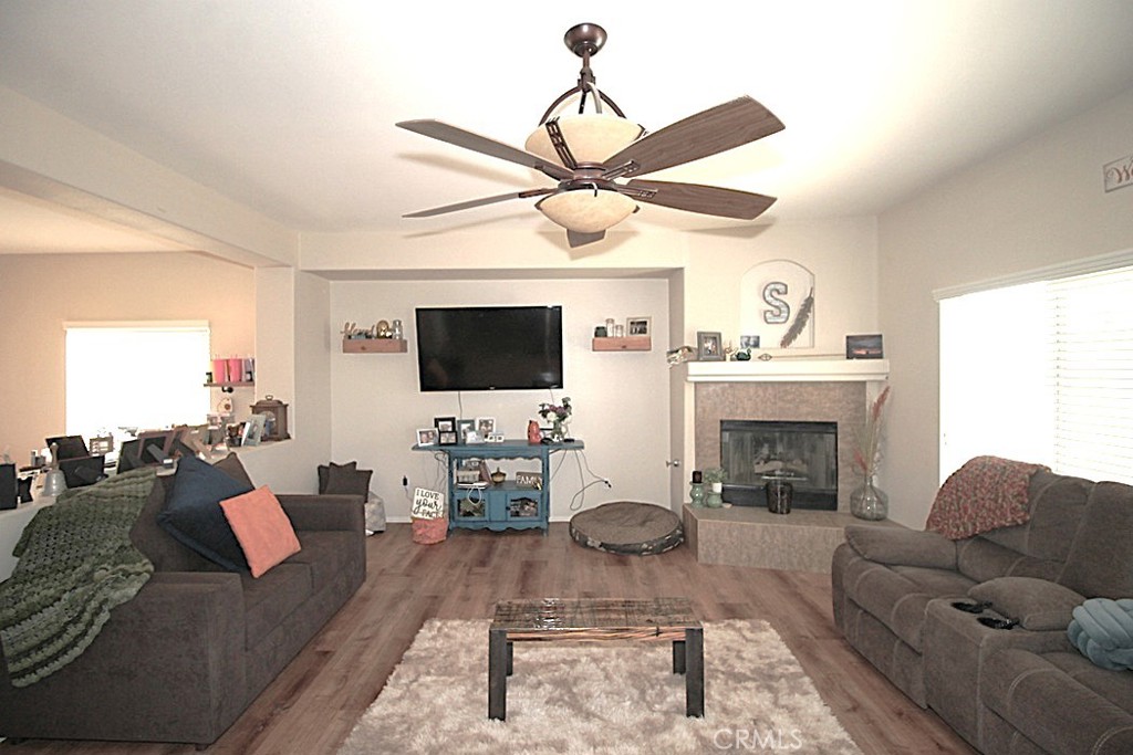 924 Condor Street Barstow, CA 92311 - Photo 10 of 52 a living room with furniture a flat screen tv and a fireplace
