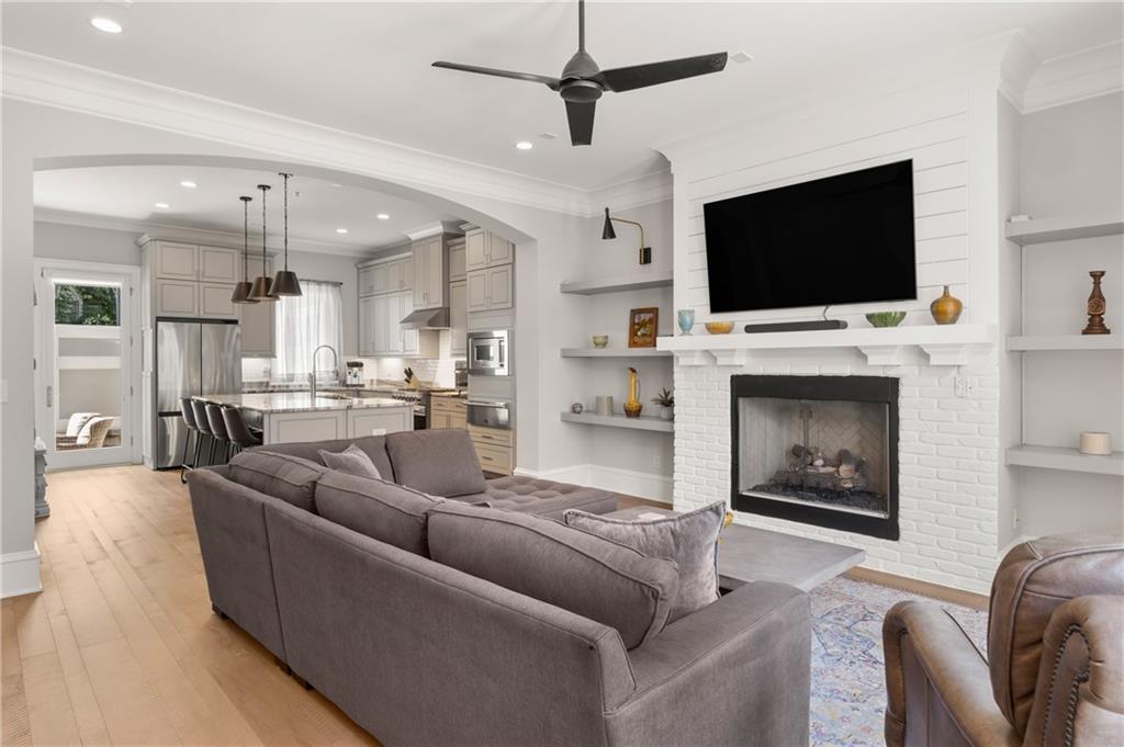 a living room with furniture a flat screen tv and a fireplace