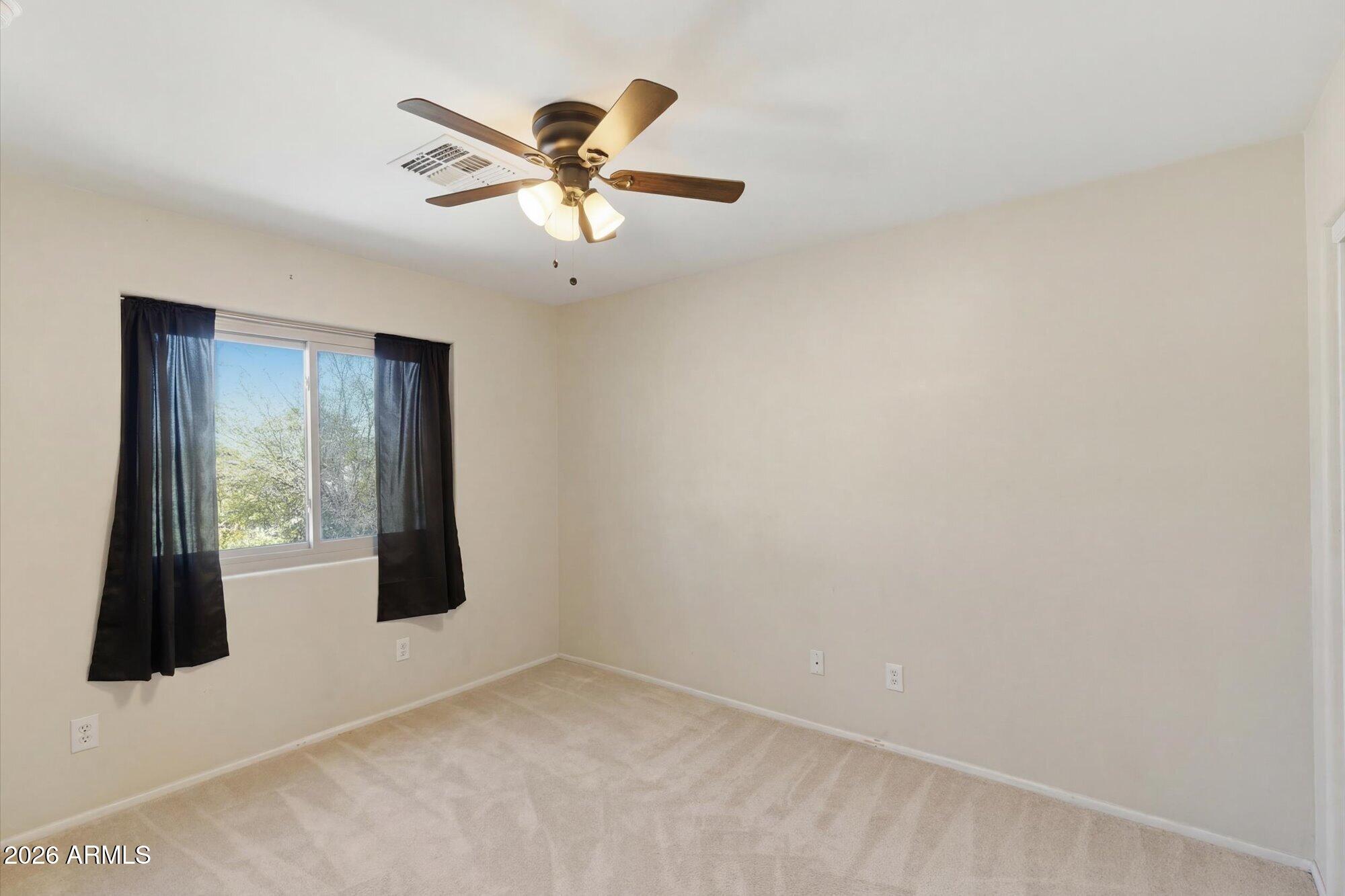 21915 Dietz Drive Maricopa, AZ 85138 - Photo 25 of 31 an empty room with windows and fan