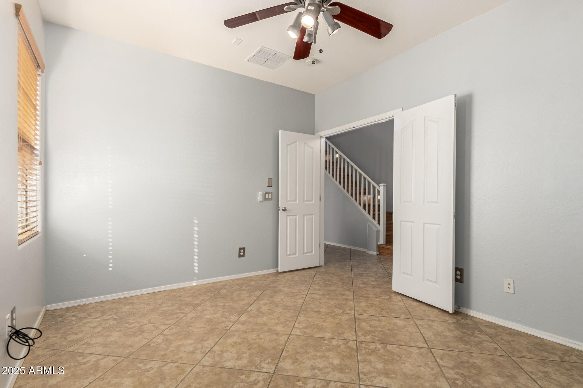 6756 South Seton Avenue Gilbert, AZ 85298 - Photo 23 of 37 an empty room with a ceiling fan and carpet