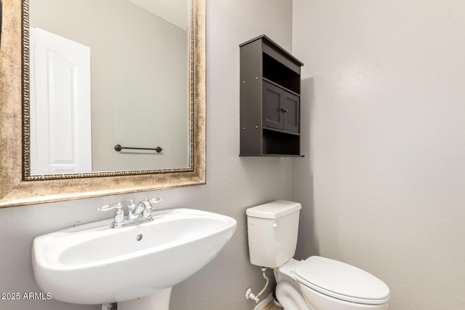 6756 South Seton Avenue Gilbert, AZ 85298 - Photo 24 of 37 a bathroom with a sink a toilet and mirror