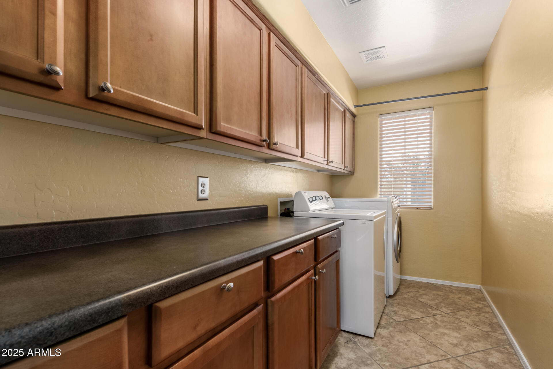 6756 South Seton Avenue Gilbert, AZ 85298 - Photo 25 of 37 a kitchen with stainless steel appliances granite countertop a sink dishwasher a stove and white cabinets with wooden floor
