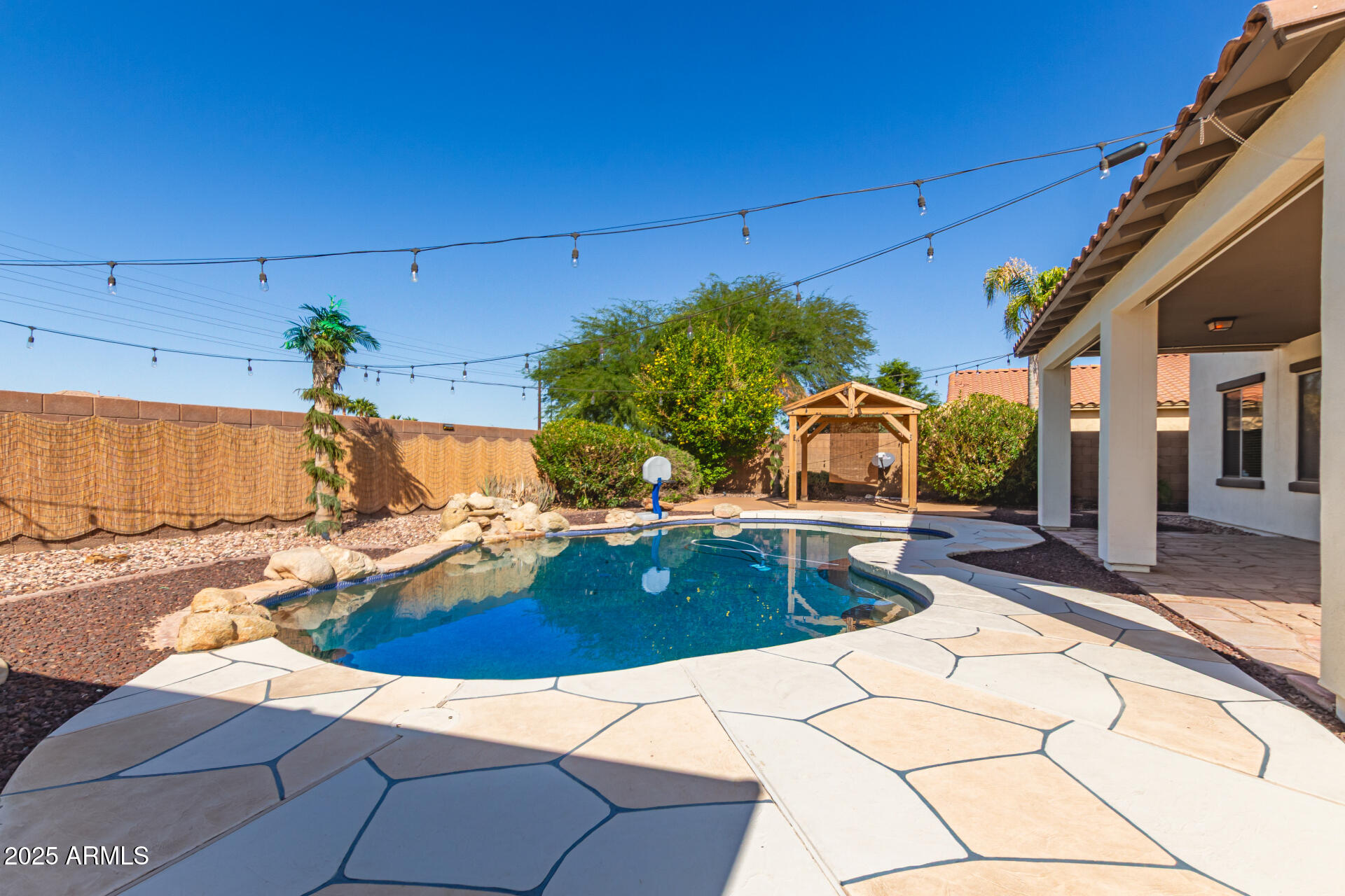 6756 South Seton Avenue Gilbert, AZ 85298 - Photo 26 of 37 a view of a swimming pool with a lounge chairs