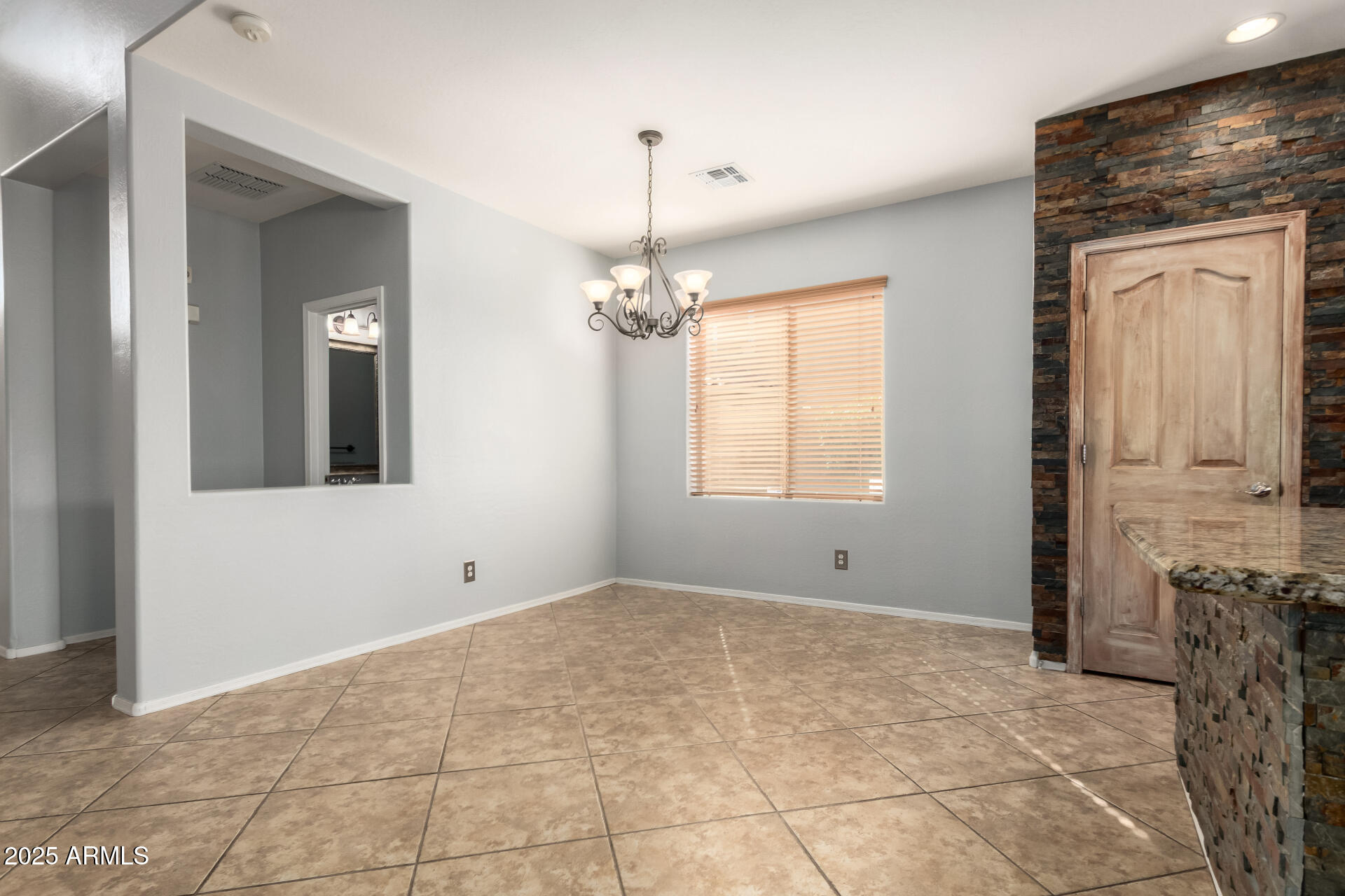 6756 South Seton Avenue Gilbert, AZ 85298 - Photo 6 of 37 a view of an empty room with window and wooden floor