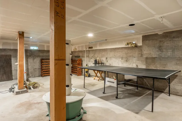 a room with stainless steel appliances kitchen island granite countertop furniture and a view of living room