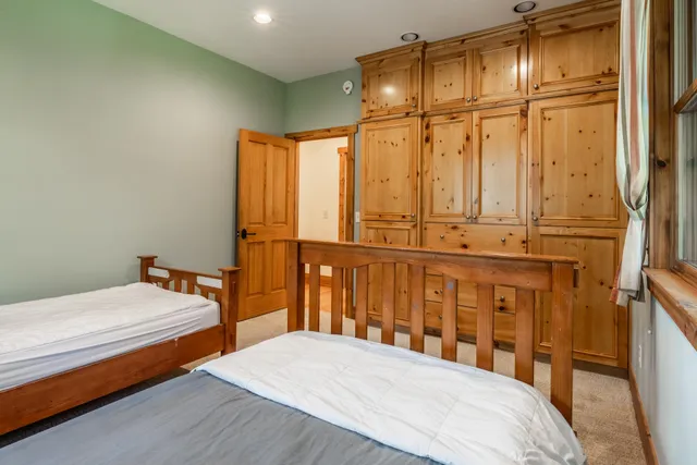 a bedroom with a bed a table and chair