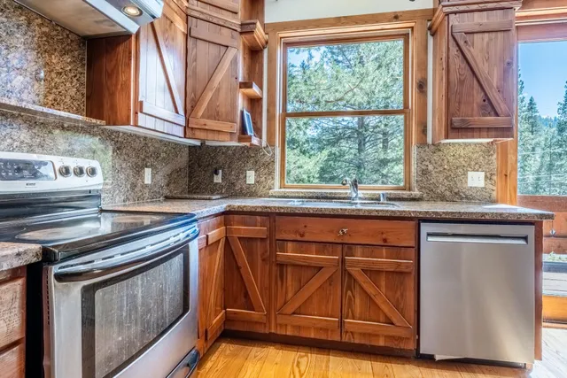 a kitchen with a sink a stove and cabinets