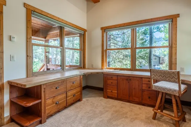 a room with a large window and chair