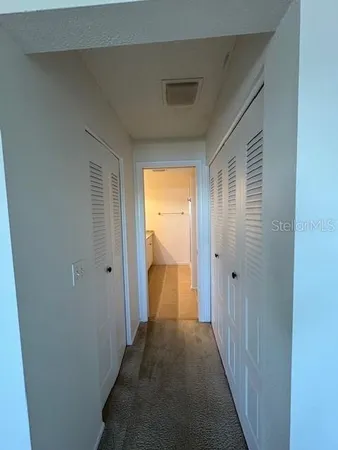 a view of a hallway with a wooden floor