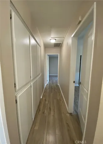 a view of hallway with wooden floor