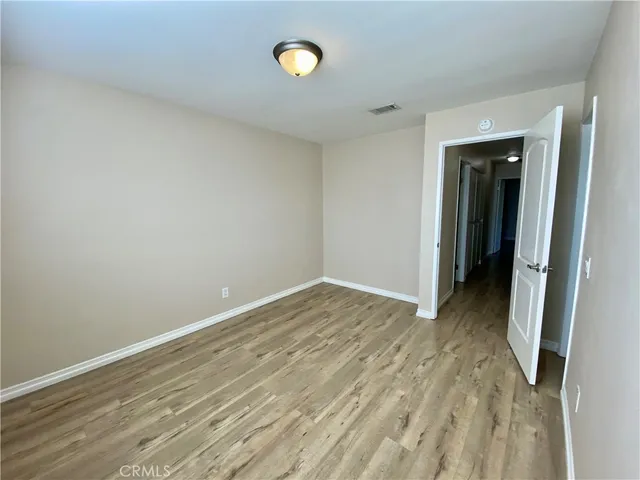 a view of hallway with wooden floor