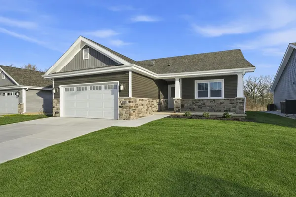 a front view of house with yard and green space