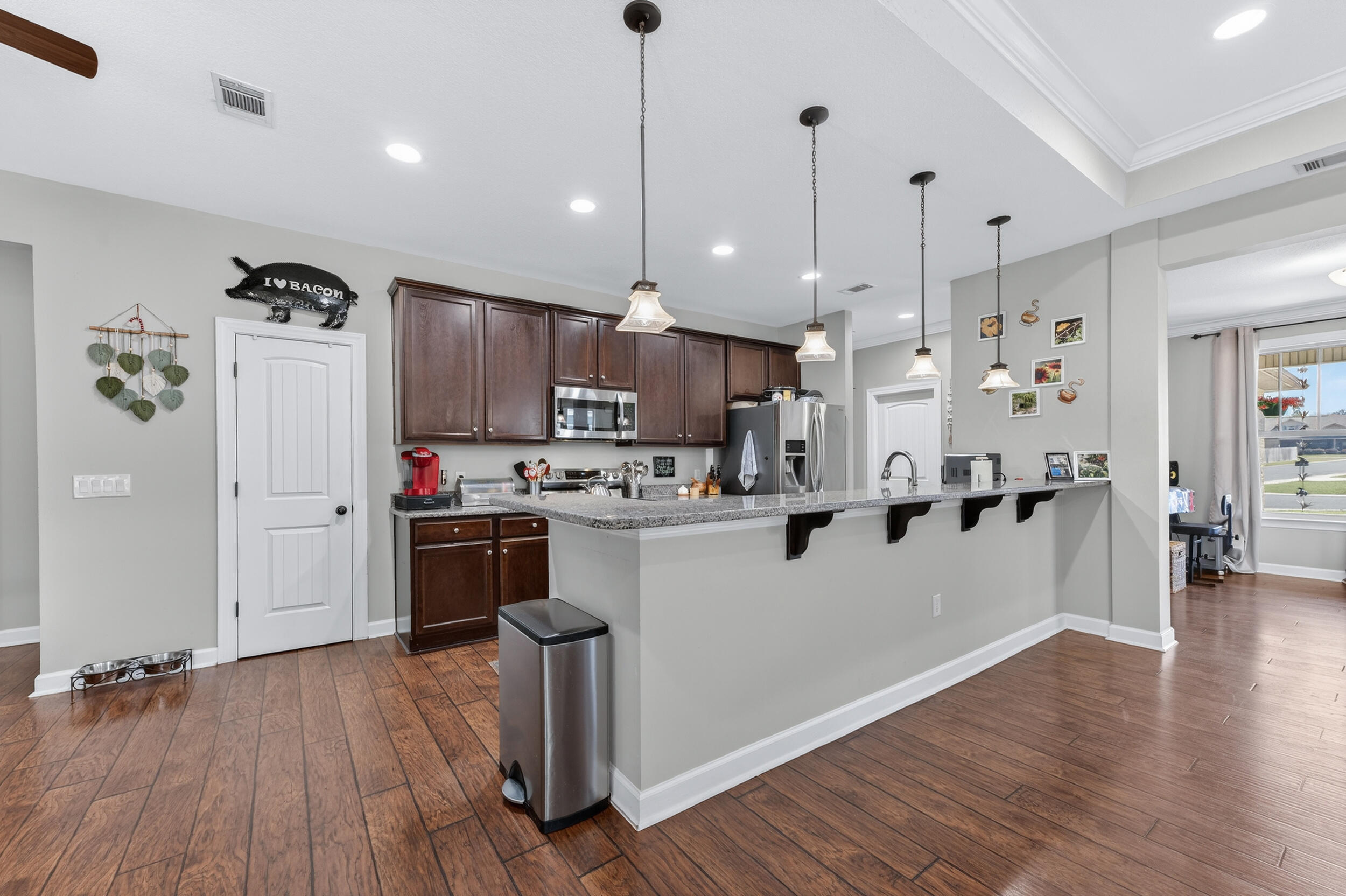 6022 Hidden Valley Road Crestview, FL 32539 - Photo 22 of 60 a kitchen with stainless steel appliances granite countertop a refrigerator a oven a stove and a wooden floors